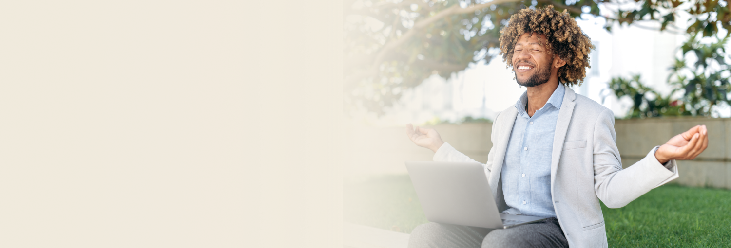 Happiness Program instructor working outdoors with laptop