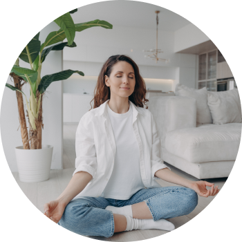 Woman in white sitting peacefully in lotus pose practicing sahaj meditation