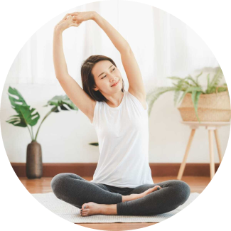 A woman practicing yoga during art of living's sahaj samadhi course